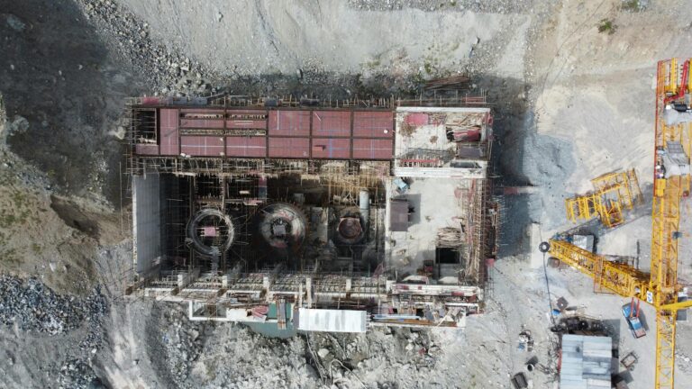 Aerial shot of a construction site with cranes in Matiltan, Pakistan, showcasing industrial progress.